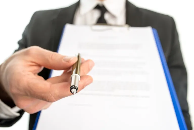 Signing business contract document close-up